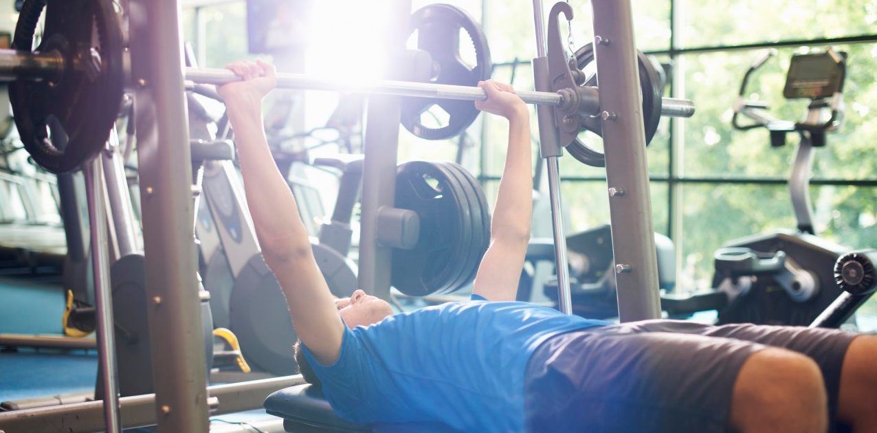 02 Jul 2014 --- Young man weight lifting with barbell --- Image by © Peter Muller/Corbis