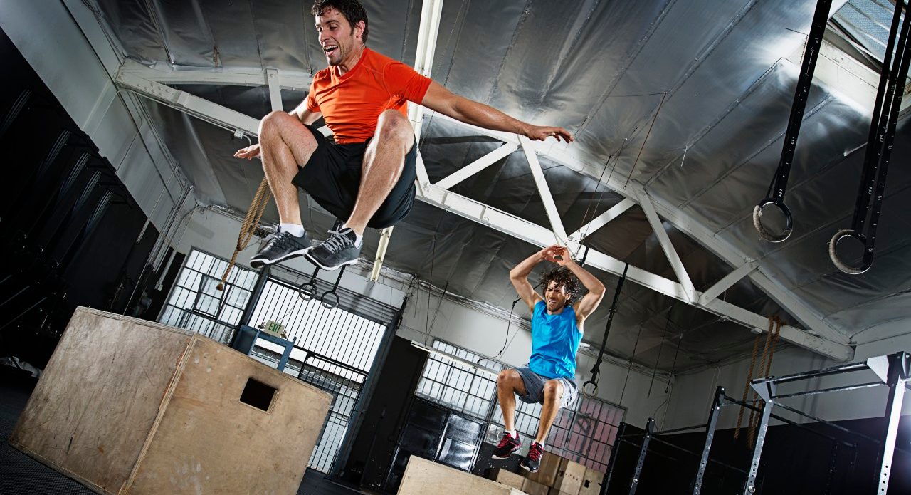 Athletes jumping in gym --- Image by © Hiya Images/Corbis