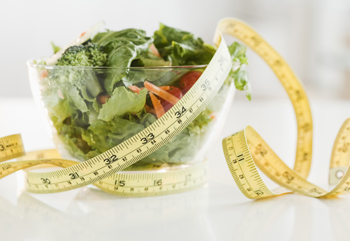 Bowl of salad and tape measure