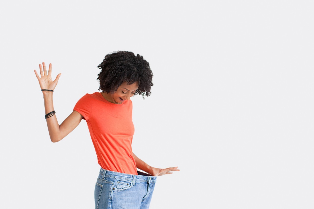 Woman with loose jeans --- Image by © Image Source/Corbis