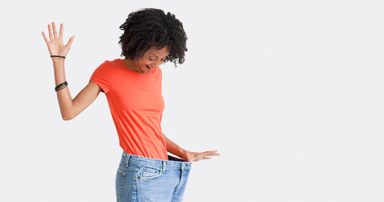 Woman with loose jeans --- Image by © Image Source/Corbis