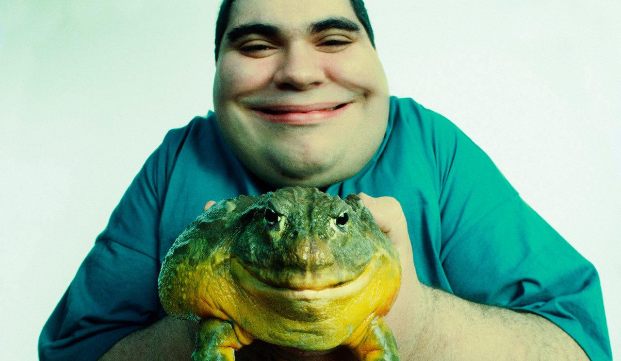 Man Holding a Smiling Toad --- Image by © Corbis