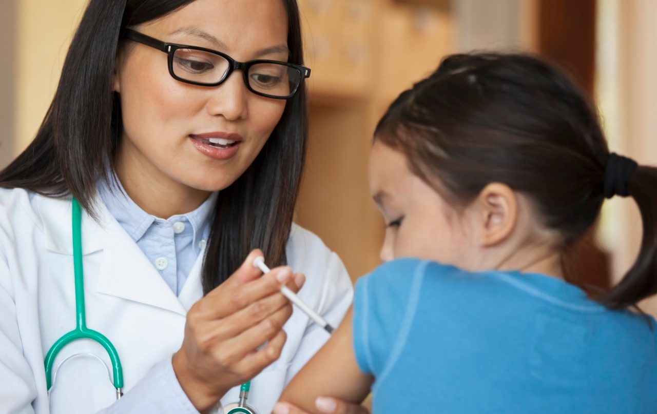 31 Aug 2010 --- Doctor giving young girl injection in arm --- Image by © Ariel Skelley/Blend Images/Corbis