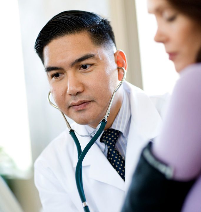 Doctor Taking Woman's Pulse --- Image by © Timothy Tadder/Corbis