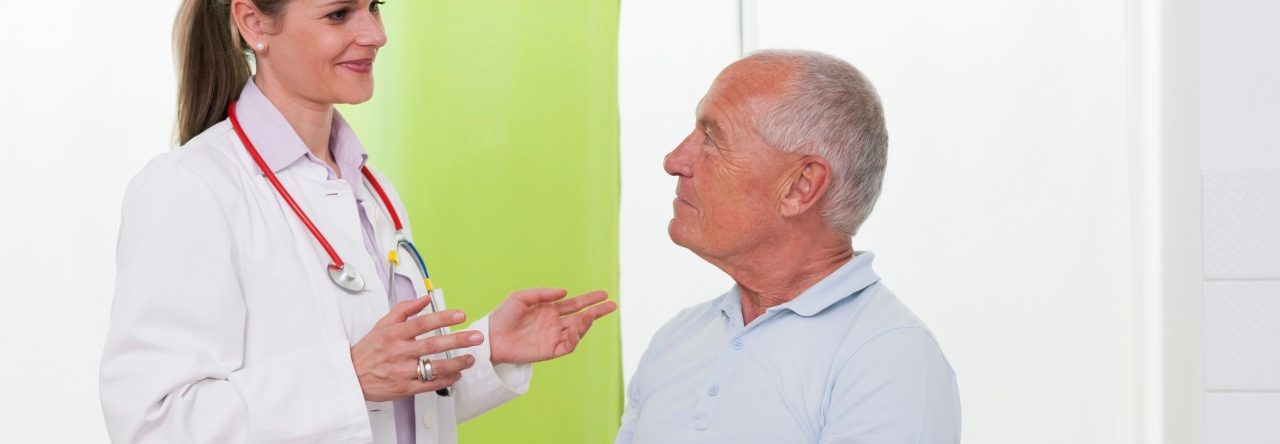 Female doctor talking to senior male patient --- Image by © Henglein and Steets/Corbis