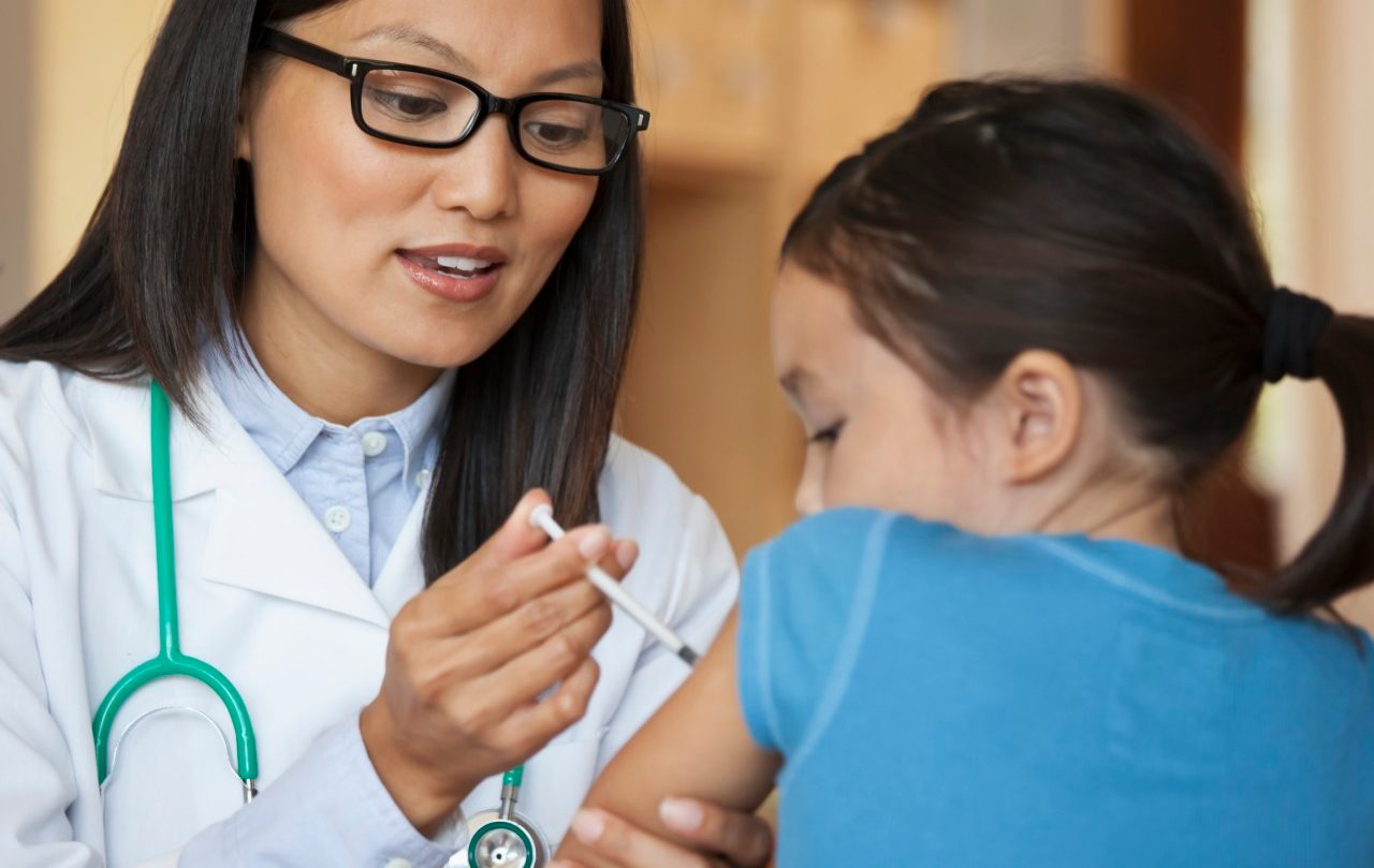 31 Aug 2010 --- Doctor giving young girl injection in arm --- Image by © Ariel Skelley/Blend Images/Corbis