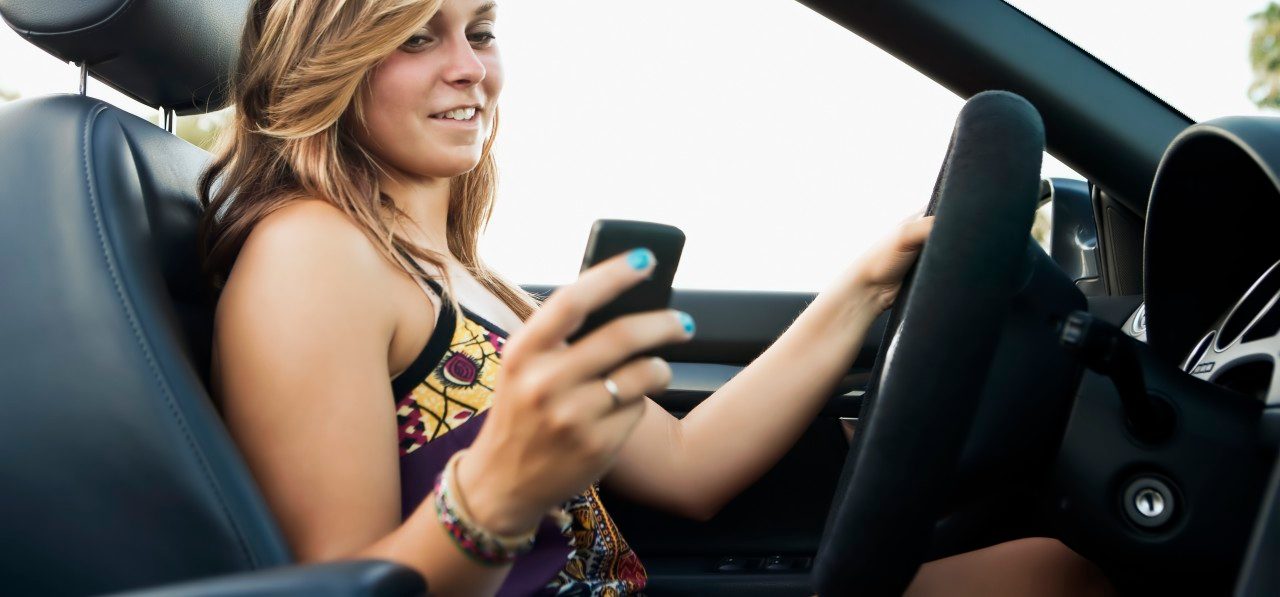 Woman driving convertible --- Image by © Sarah M. Golonka/Tetra Images/Corbis