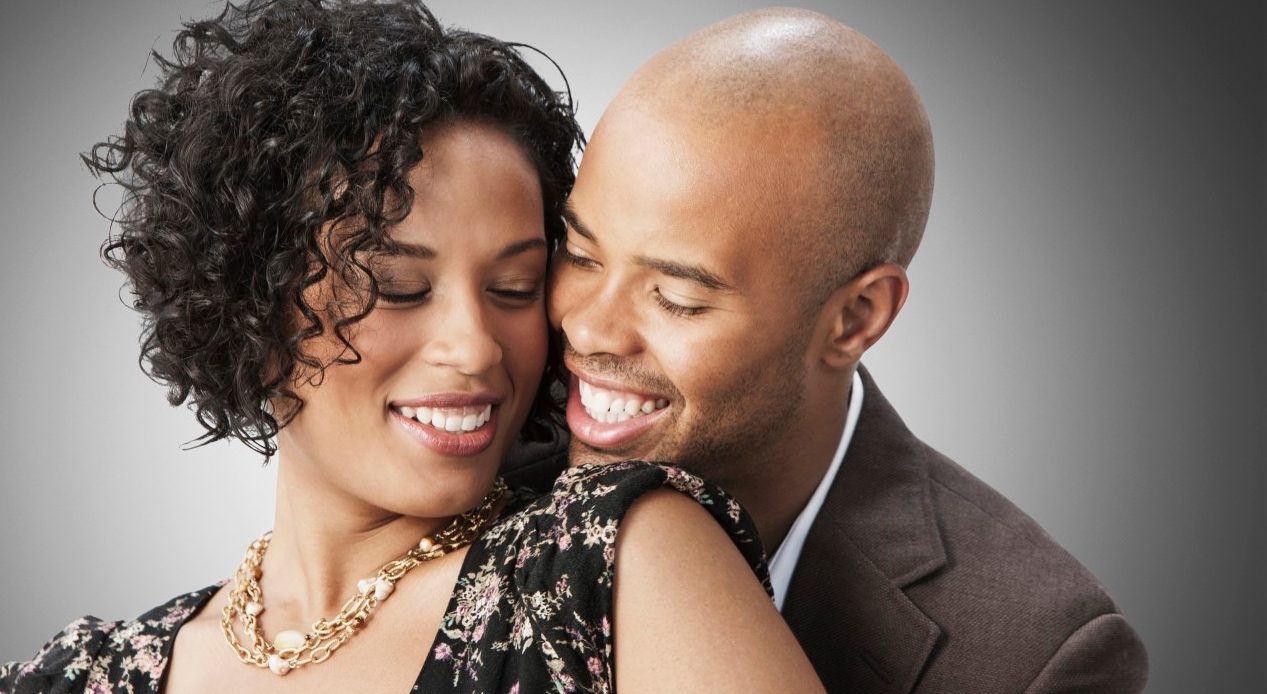 26 Sep 2012 --- Smiling mixed race couple hugging --- Image by © Jose Luis Pelaez Inc/Blend Images/Corbis