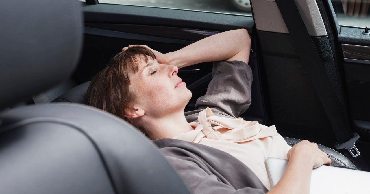 17 Aug 2014 --- Germany, portrait of businesswoman relaxing in a car --- Image by © Jo Kirchherr/Westend61/Corbis