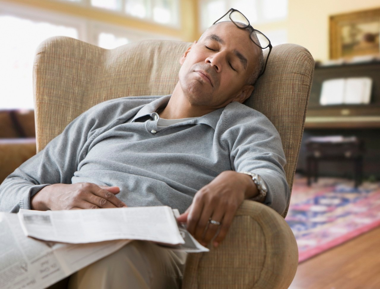 18 Aug 2011 --- Mixed race man sleeping in armchair --- Image by © Jose Luis Pelaez Inc/Blend Images/Corbis