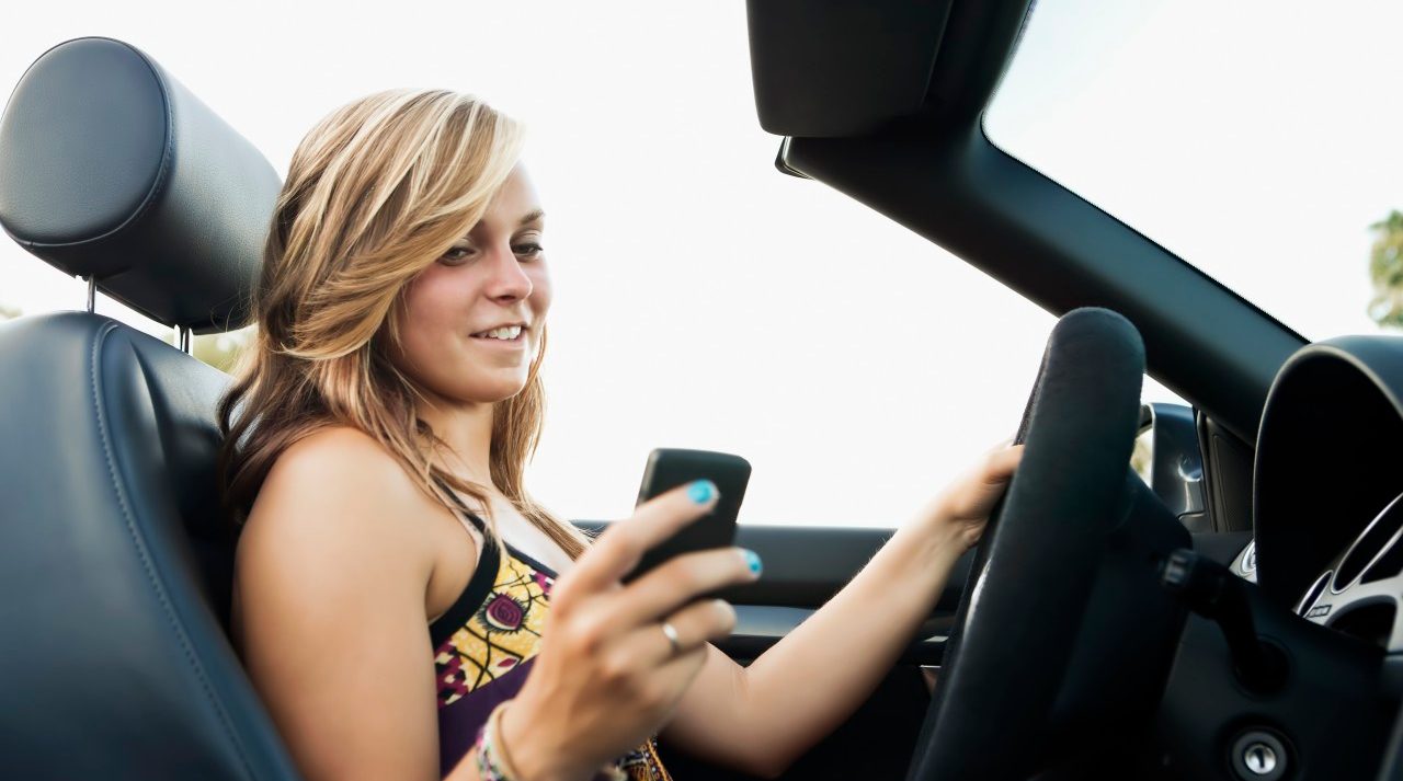 Woman driving convertible --- Image by © Sarah M. Golonka/Tetra Images/Corbis