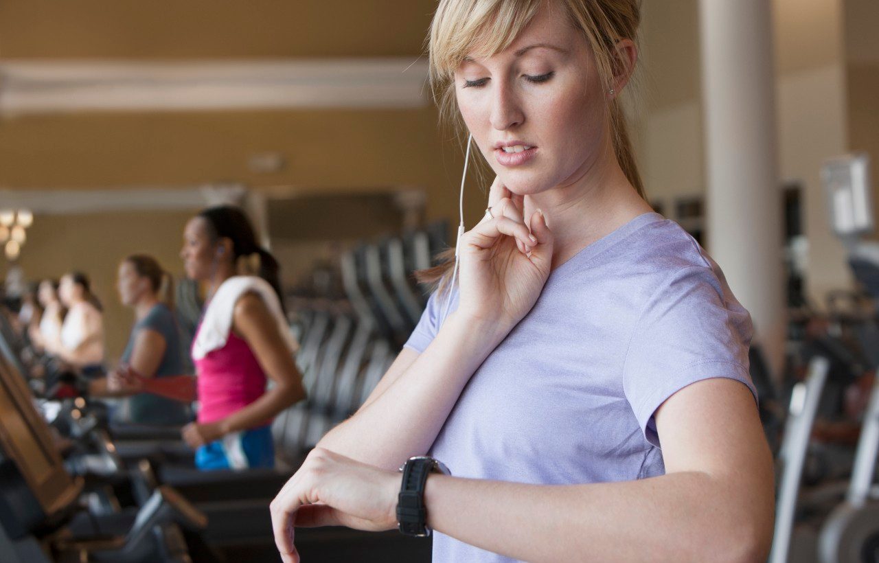 11 May 2012 --- Caucasian woman checking pulse in gym --- Image by © Jose Luis Pelaez Inc/Blend Images/Corbis