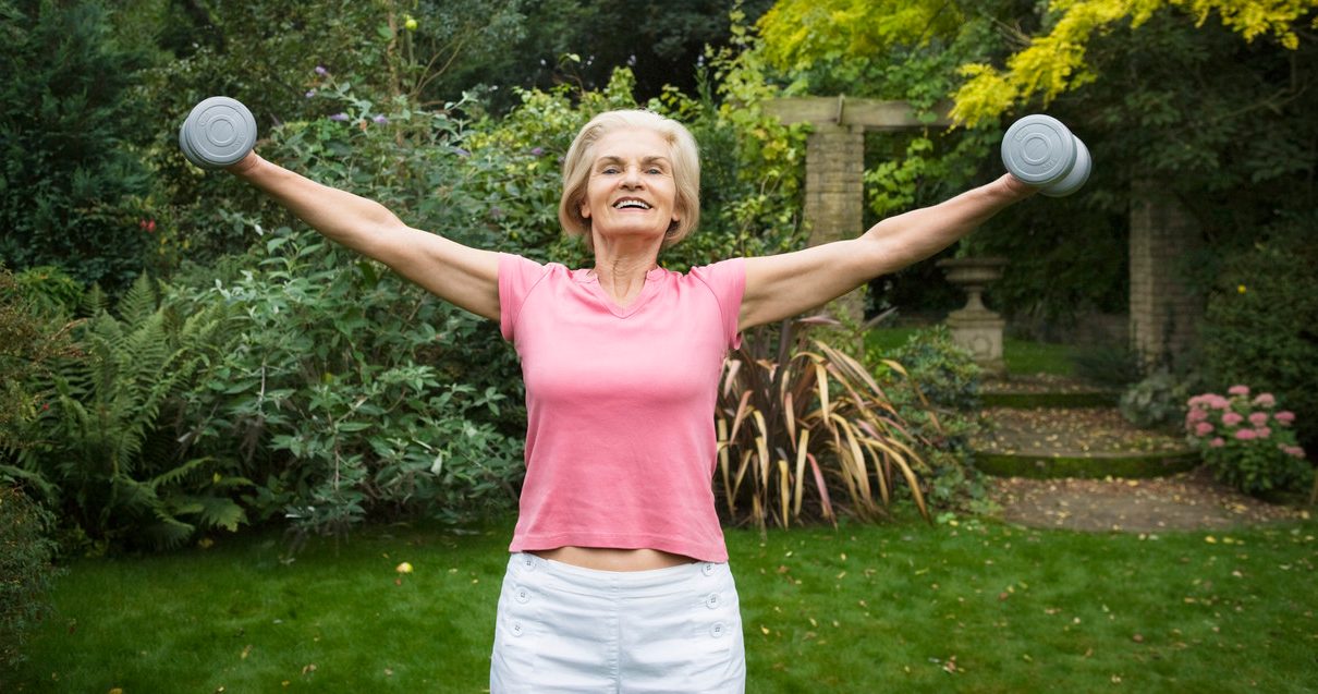 Woman Lifting Weights --- Image by © Betsie van der Meer/Corbis