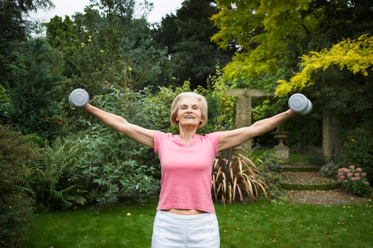 Woman Lifting Weights --- Image by © Betsie van der Meer/Corbis